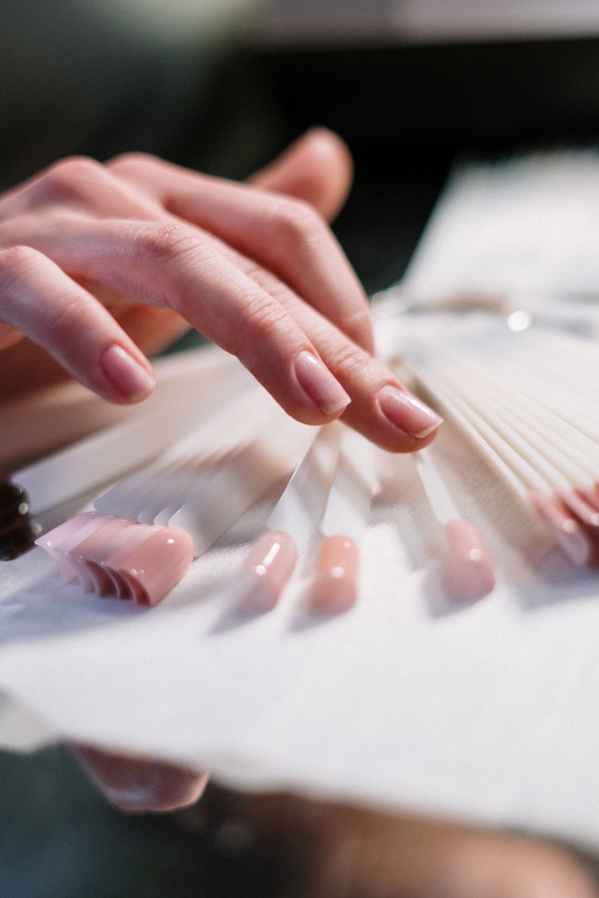 Nail technician finishing a set at Ombré Nail Bar